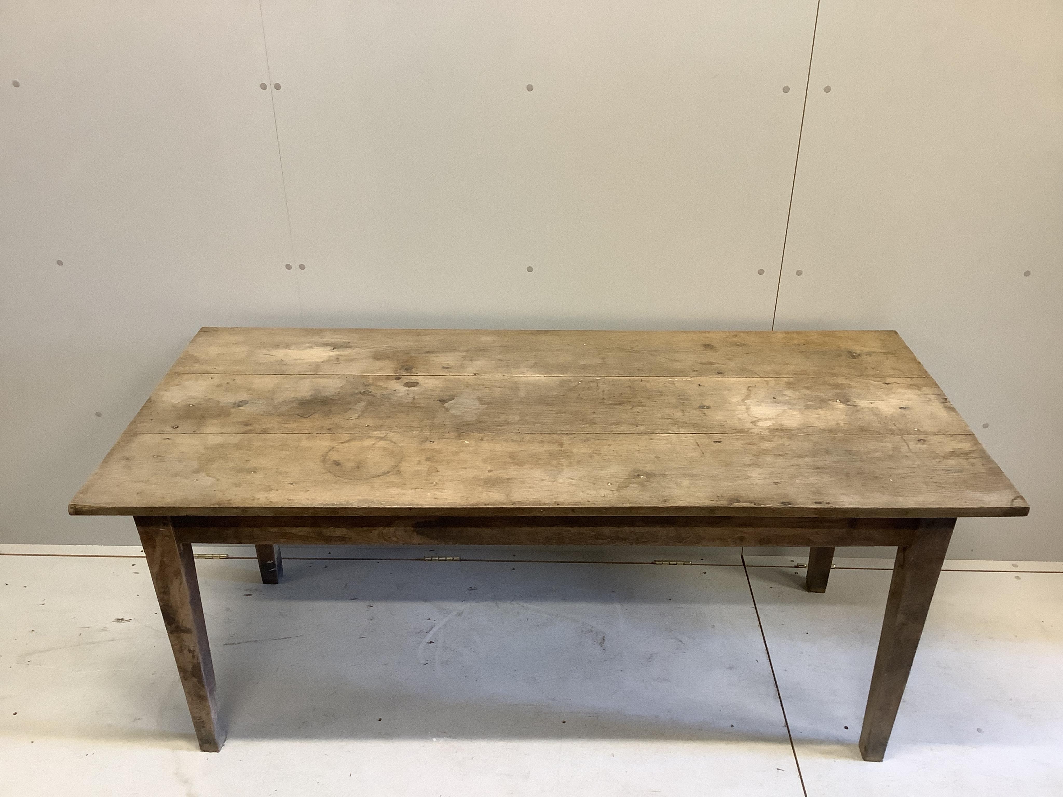 A 19th century French oak and walnut kitchen table, width 175cm, depth 78cm, height 76cm. Condition - faded and stained but essentially solid